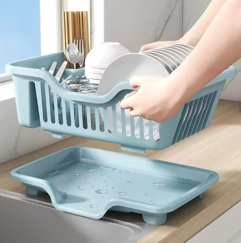 Blue dish rack with dishes on a kitchen counter